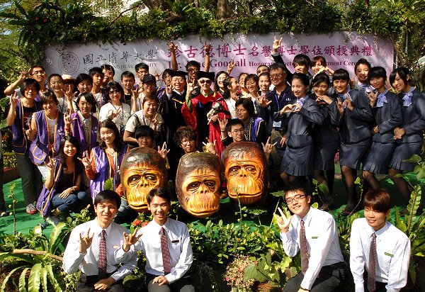 學生志工與珍古德博士合影留念，前排為三個學生手作的黑猩猩面具