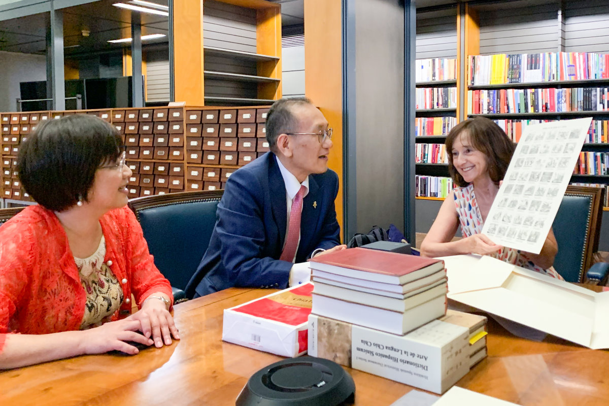 我國駐西班牙劉德立大使(中)代表本校贈書給西班牙國家圖書館，館長亞蘭布羅女士(右)回贈珍貴的館藏古文獻複製品